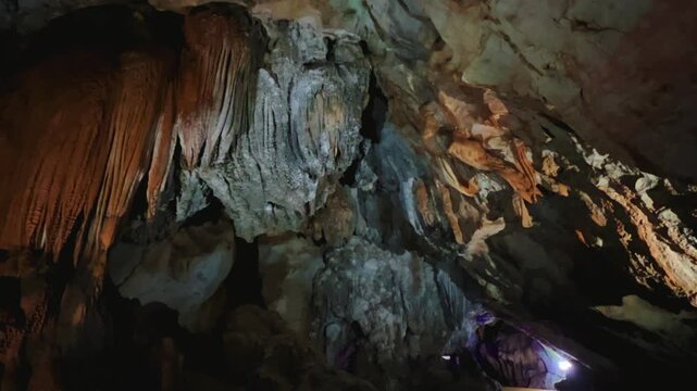 Wang Vieng, Laos.Tham Jang Cave-stalactites and stalagmites in a karst mountain with a Buddha temple inside. There is a spring inside the cave. The cave is equipped with comfortable paths and lanterns