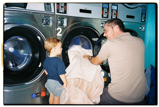 Father and son at laundromat
