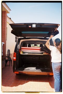 Woman Closing Van After Loading