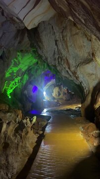 Wang Vieng, Laos.Tham Jang Cave-stalactites and stalagmites in a karst mountain with a Buddha temple inside. There is a spring inside the cave. The cave is equipped with comfortable paths and lanterns