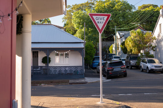 Give Way traffic sign on quiet suburban street  