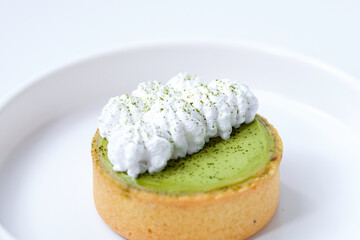 Matcha cheese tart on a white plate