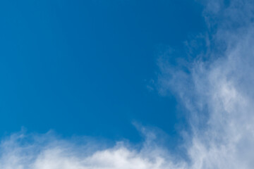A bright, clear blue sky meets a glowing white horizon, suggesting a serene, open, and with sunlight of beautiful cloudy sky. landscape or abstract background.	