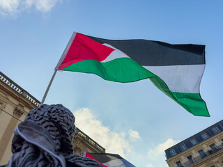 Palestinian Flag Raised During Gathering in Urban Setting