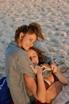 Twin Sisters Embracing at Sunset