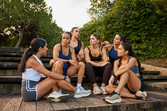 Group of women having a discussion outdoors in a park setting