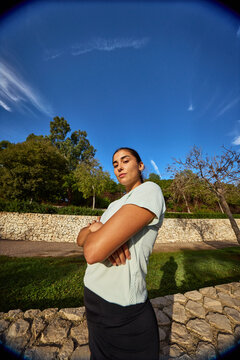 Confident athlete enjoying outdoor workout under blue sky