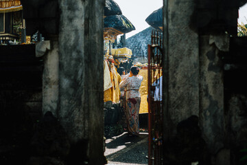 Balinese women offering incense and ceremonial items at temple