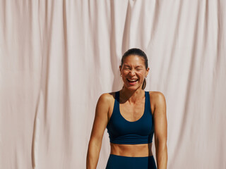 Woman Enjoying Exercise in Activewear Against a Light Backdrop