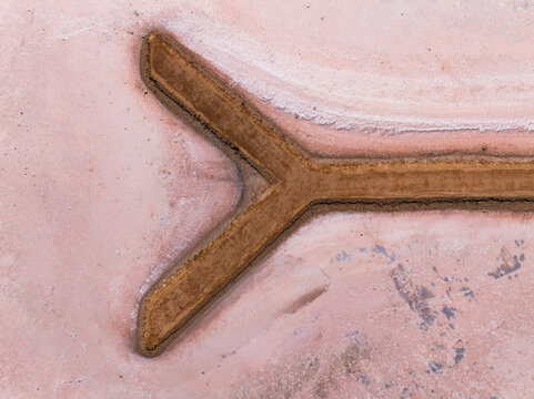 Y sahped walkway out onto a pink salt lake