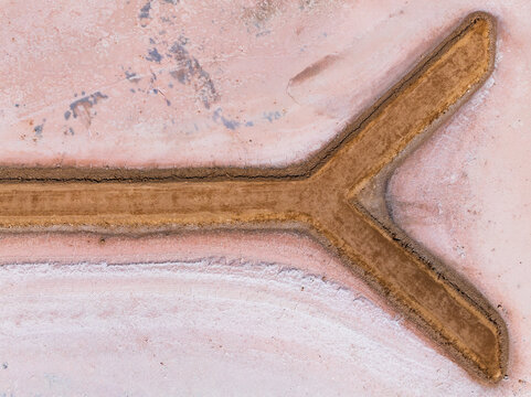 Y sahped walkway out onto a pink salt lake