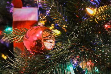 70's glass globe lantern toy on a Christmas tree with colorful lights