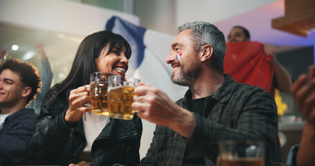 Event, couple and cheers with beer at pub for world cup win, football match celebration or bonding. Happy hour, relationship and mature people with drinks toast for France game success and night out