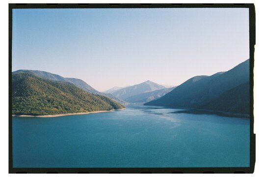 Beautiful mountain landscape with serene lake and clear blue sky 