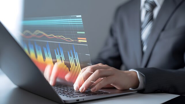 Hands of a professional analyzing luminous financial data displays on a laptop for strategic business growth - Powered by Adobe