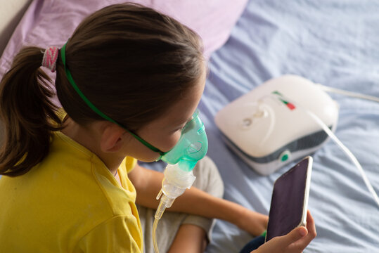 Child with a nibulaise mask inhales.