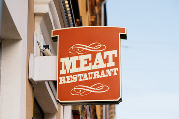 Signboard of Meat Restaurant Showcasing Vibrant Colors and Design