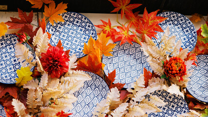 Colorful Fall Display With Decorative Plates and Leaves