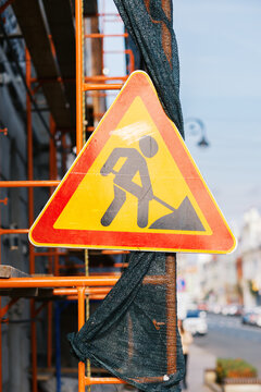 Construction Sign Warns of Work Ahead in a Busy Street