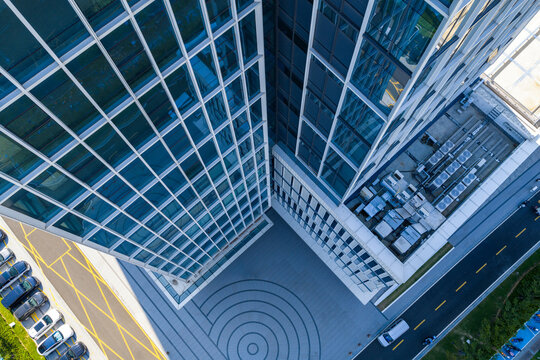 Aerial view of modern glass skyscraper with reflective facade