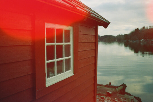 Traditional Norwegian hut next to fjord