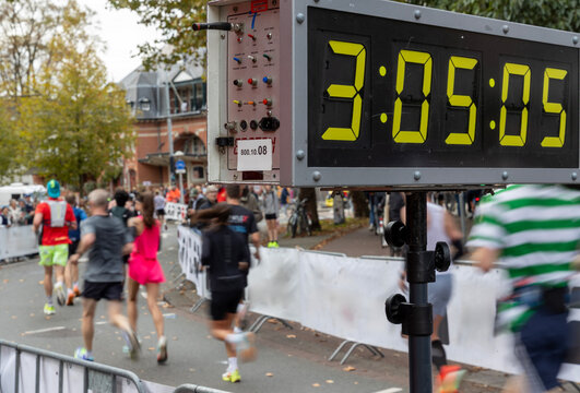 clock and marathon runners