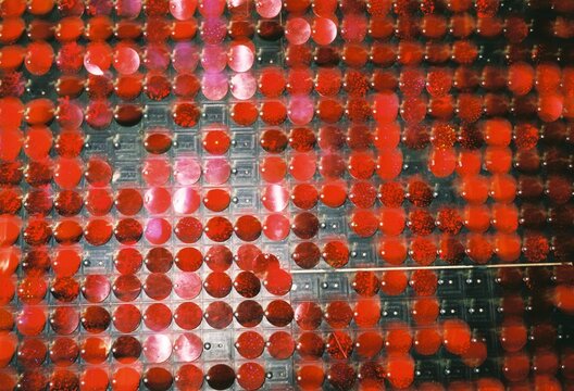 Red plastic dots on a metal wall