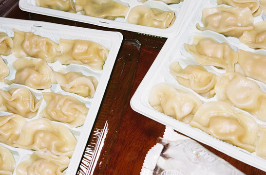 Steamed dumplings on plastic containers