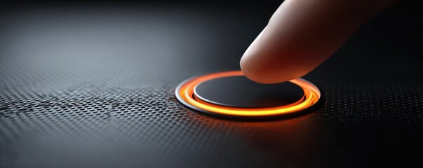 Finger pressing go button with orange light concept. A finger pressing a glowing touch-sensitive button.