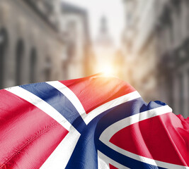 Norway flag fluttering on blur street with building. Norway national flag for independence day.
