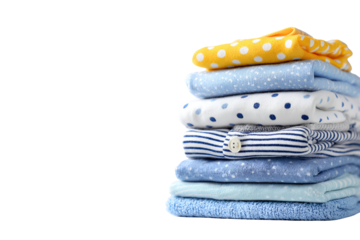 Neatly folded stack of baby clothes and blankets in various blue and yellow patterns