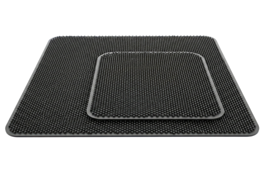 Square black silicone drying mat with textured raised dotted surface on isolated background