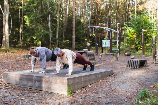 Two Women Doing plank Together at an Outdoor Gym