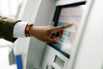 User Interacts With Touchscreen at Automated Banking Kiosk