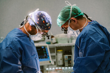 Surgeons performing complex surgery in operating room