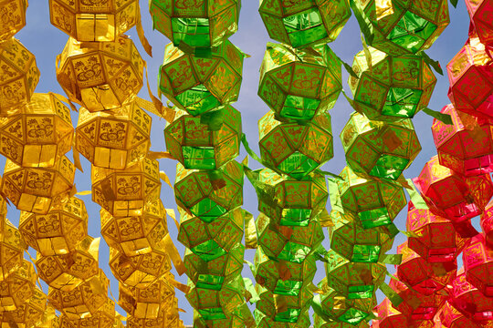 Many Colorful Lanterns Decorating a Clear Bright Blue Sky.