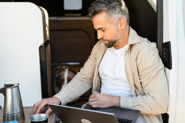 Man working in cozy camper van