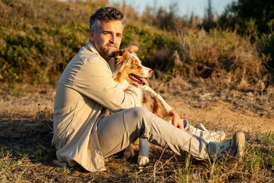 Man relaxing outdoors with his dog