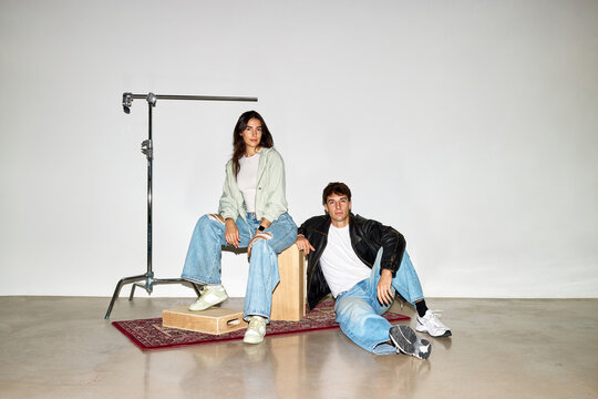 Couple poses on studio set during fashion photo shoot