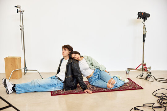 Young couple posing together in a studio setting