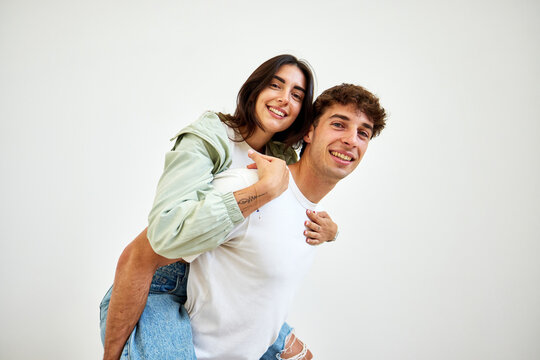 Couple sharing a joyful moment with a playful piggyback ride