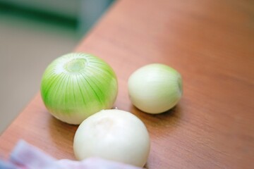 Peeled onion bulbs lying on a dining table before cooking preparation