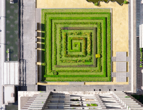 Geometric Spiral Garden and Modern Urban Architecture Aerial Vie