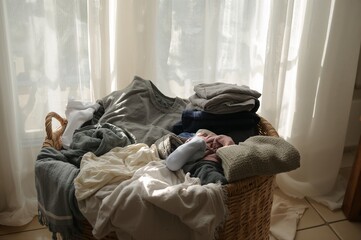 Overflowing Laundry Basket - Wicker Container Filled with Clothes, Sunlight Streaming Through Curtains.