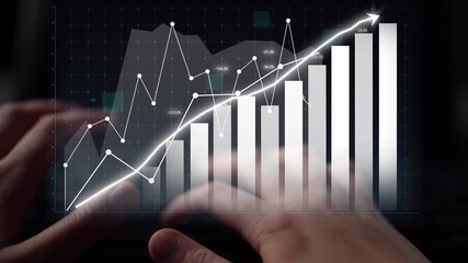 A business professional engages with financial data on a digital platform, focusing on a growth graph. This image highlights the intersection of technology and finance for analysis. Copula - Powered by Adobe
