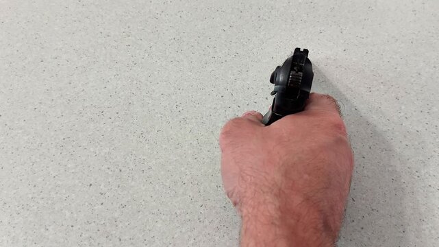 Steady hand demonstrates controlled trigger press on sleek black air gun, highlighting precision, discipline, and smooth mechanics in a focused shooting setup