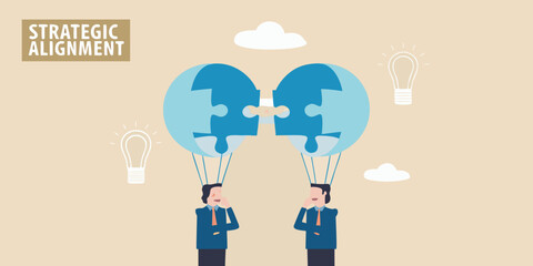 Two businessmen connect puzzle pieces representing strategic alignment and ideas