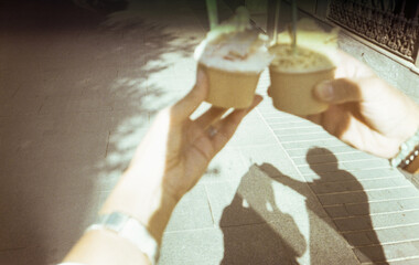 Film UGC image of couple showing ice cream cups outdoors