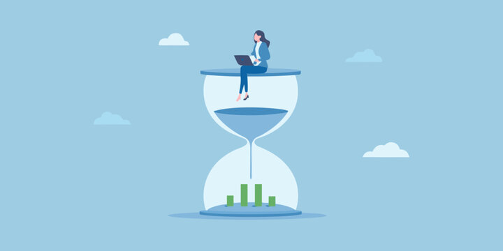 Businesswoman working on laptop on top of hourglass with financial chart below