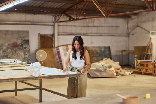 Artist working on a project in a spacious studio setting